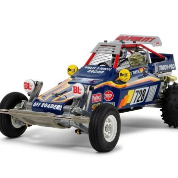 The Fighting Buggy was originally exported as the Super Champ in 1982 across the globe. For a limited time only, it is back as a special re-release celebrating 36-plus years after it originally made its debut in hobby stores. The re-release kit begins with a new name, which is the same as that used by the original Japanese release of the R/C model. While it features a variety of tweaks and upgrades, Tamiya's designers made sure to retain the drivability, appearance and characteristics of the original. • 1/10 scale R/C model assembly kit. • The classic body of the original is reproduced in durable ABS resin with an aluminum roof panel with wing. • Stickers retain many of the themes of the classic model while also adding some new motifs. • Lightweight and durable 2.5mm thick FRP chassis plate is compatible with Item 55105 Tamiya LF Battery LF1100-6.6V Racing Pack (M-Size) (sold separately). • Original transverse damper rear suspension setup with progressive spring and separate oil reserve tank is again employed. Front suspension is double trailing arm type. Front/rear sus arms are die-cast. • Employs durable die-cast sealed gear case with direct drive setup, which also houses the motor. • Ribbed front and rear spike tires. They are fitted securely to 3-piece wheels. • Type 540 motor included. • Comes in nostalgic blister pack style packaging. • Requires: 2-channel radio, steering servo, ESC, small 7.2volt battery pack with compatible charger, and Tamiya TS Paint.